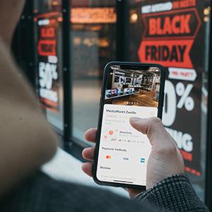 Man on phone looking at business info