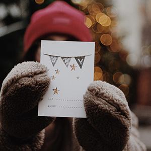 Woman holding up a Christmas card