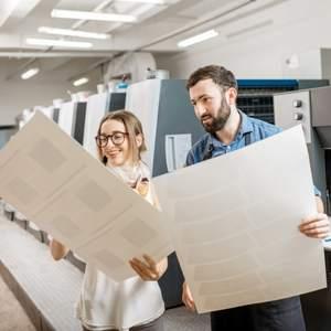 A woman looking at prints at a professional printing business
