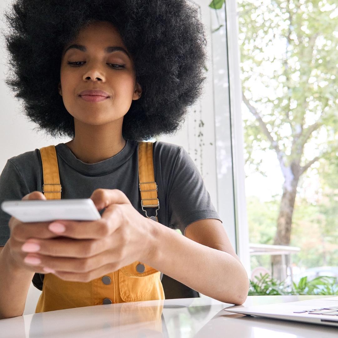 young woman using a qr code with her phone