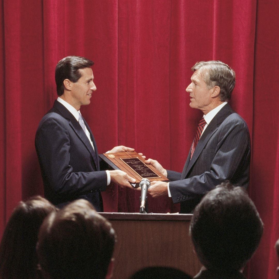 man being awarded a plaque