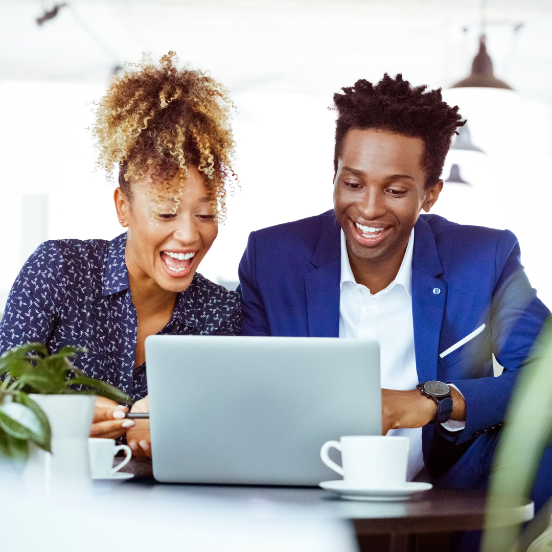man and woman looking at computer