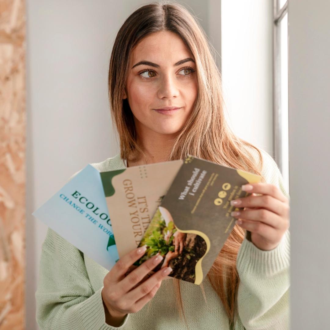 woman holding up numerous flyers