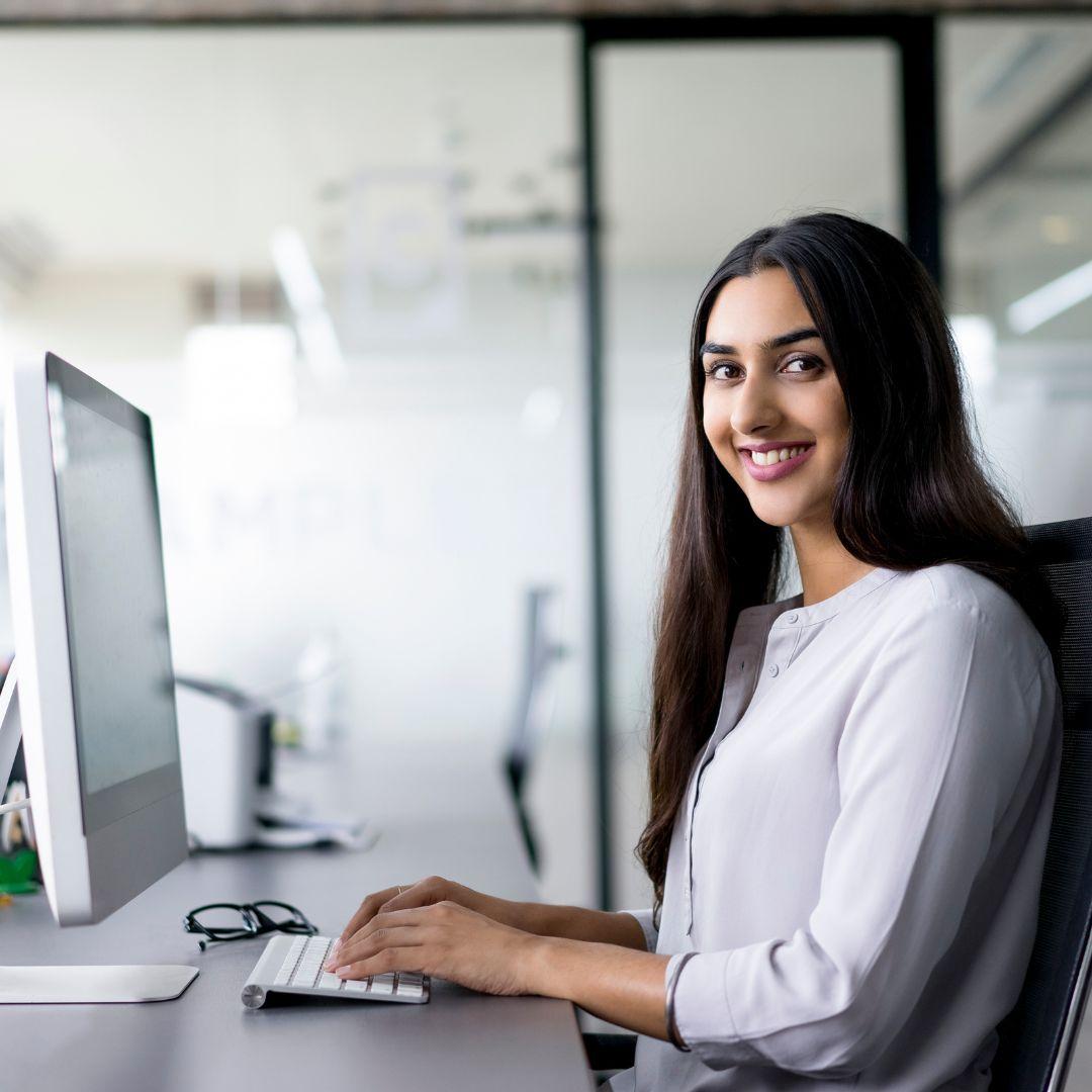woman at computer smiling