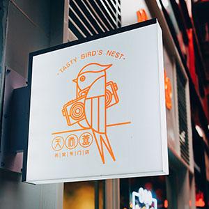 A illuminated restaurant sign on the exterior of a building
