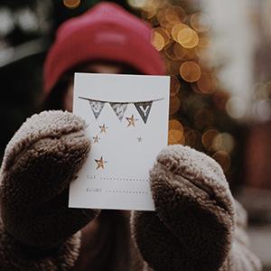 Woman holding up Christmas card