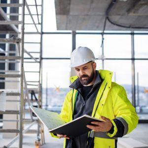 Engineer looking at blueprint book