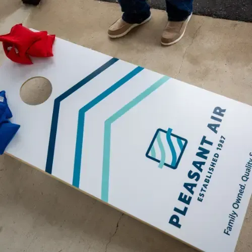 Cornhole set branded with Pleasant Air HVAC branding