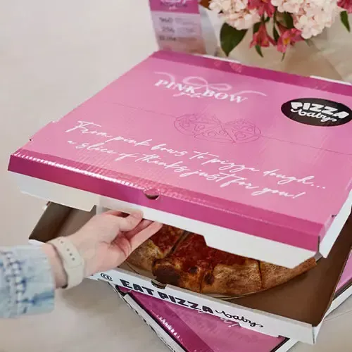 Pizza in a pink box that says