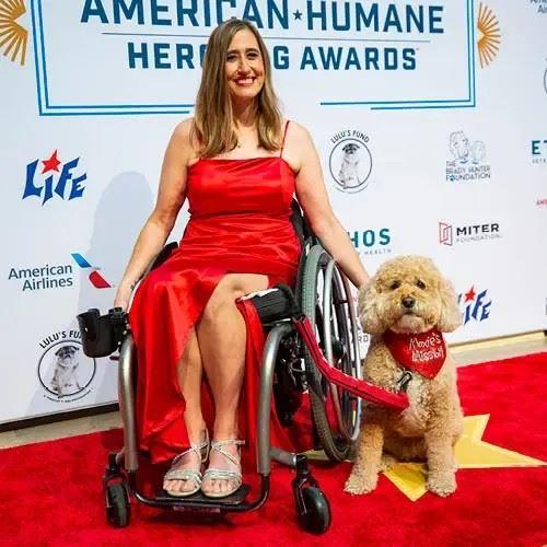 A Hero Dog and their human pose on the red carpet