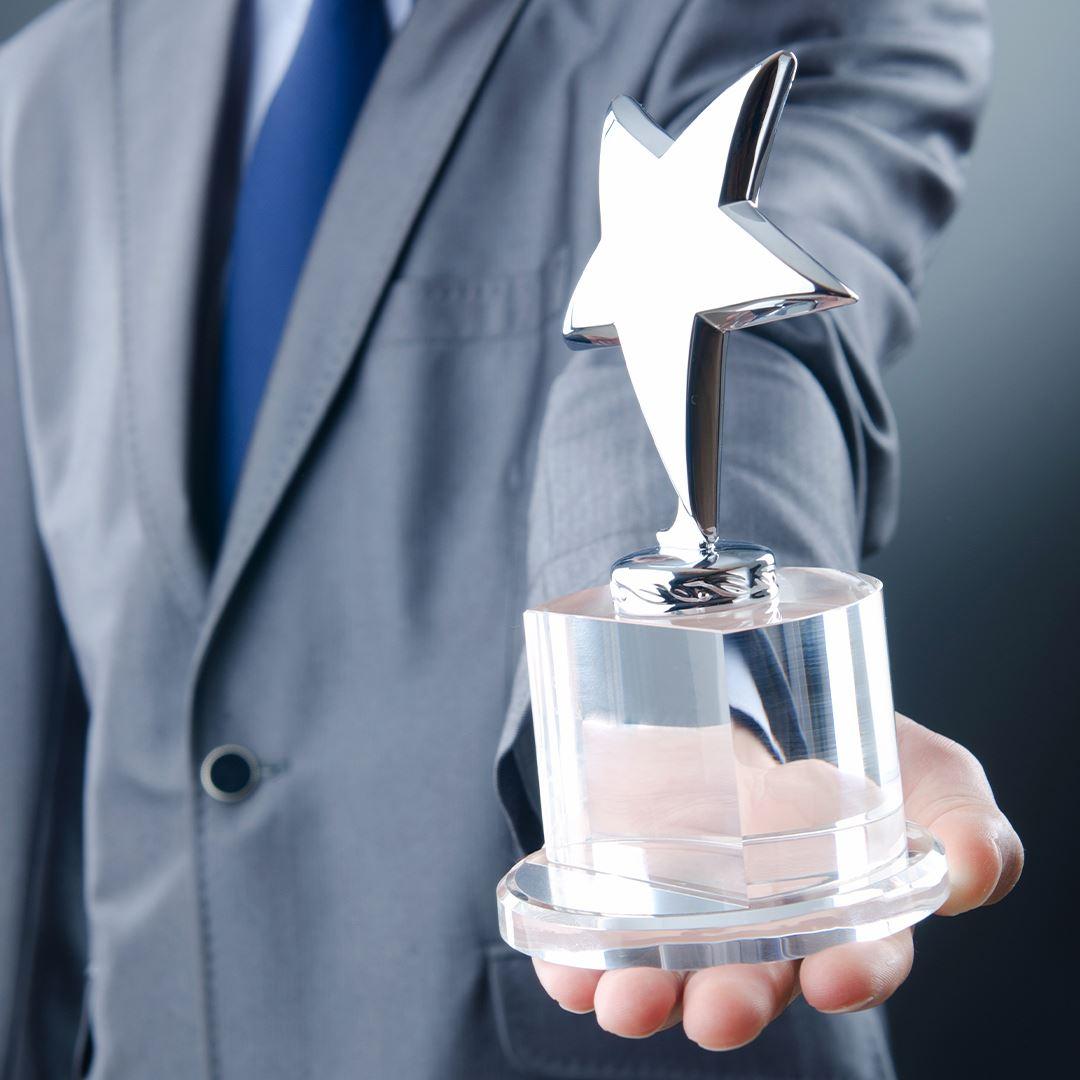 a business man holding an award