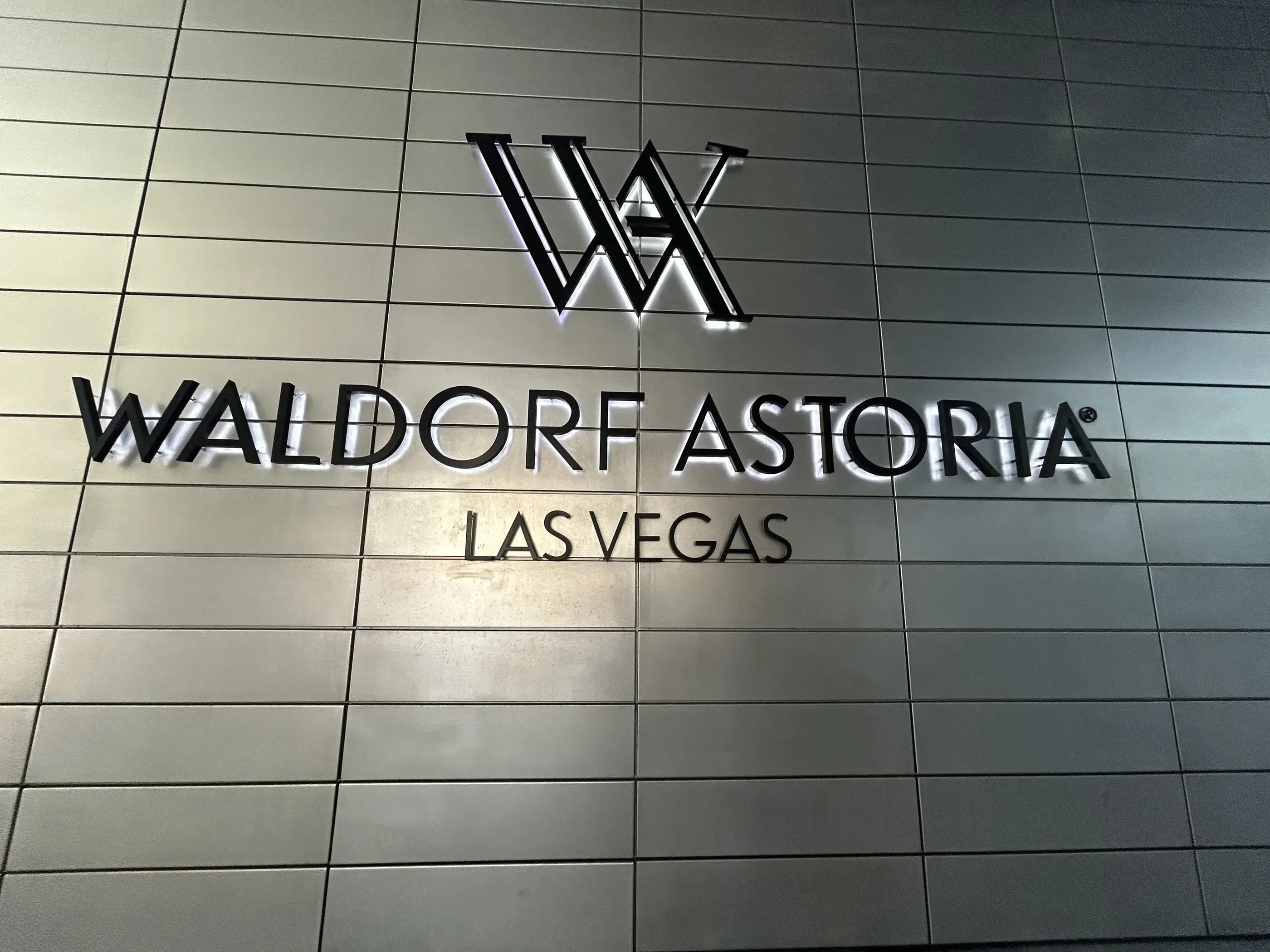 Backlit dimensional letter sign for Waldorf Astoria Las Vegas on an exterior wall.