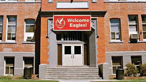 banner hung above exterior door of school