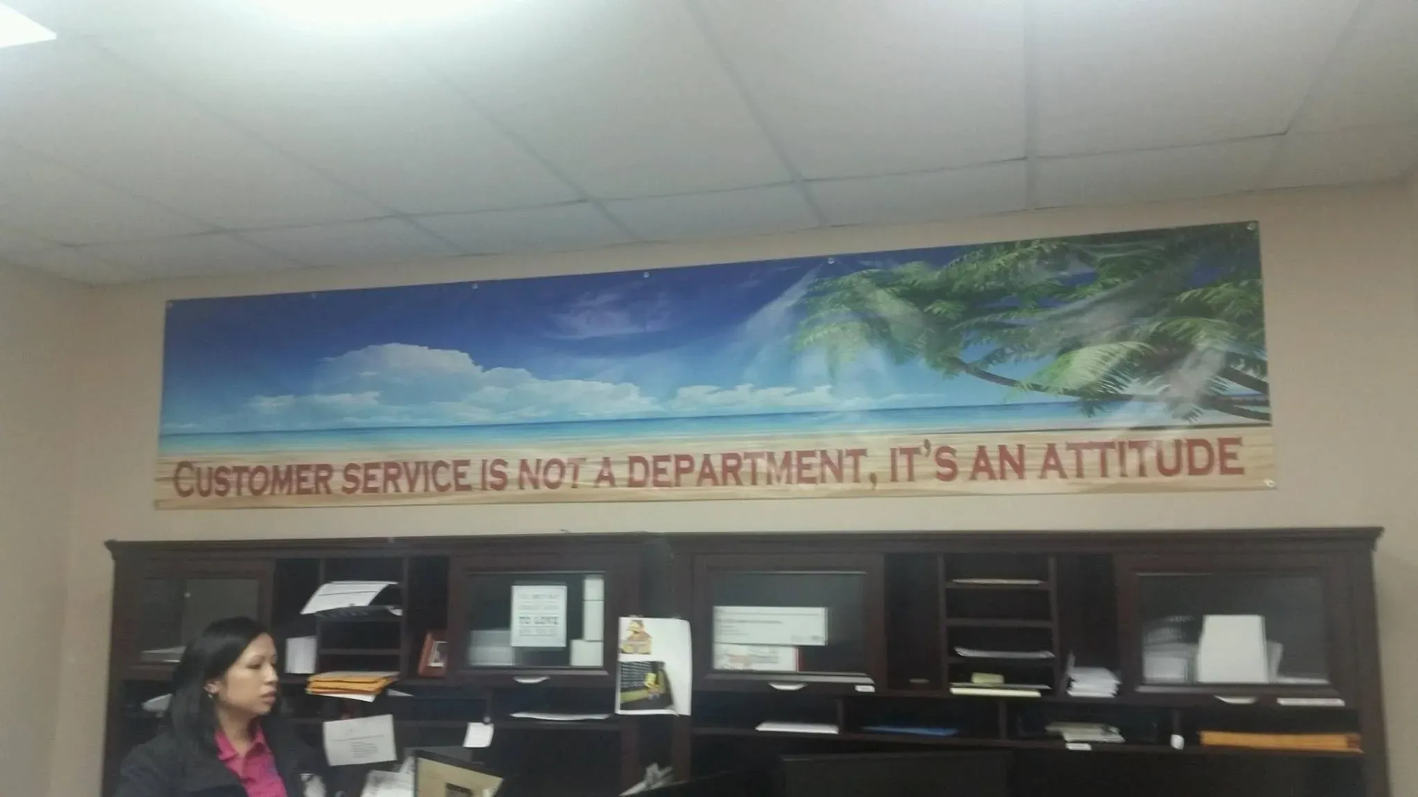 Indoor wall banner above a customer service desk