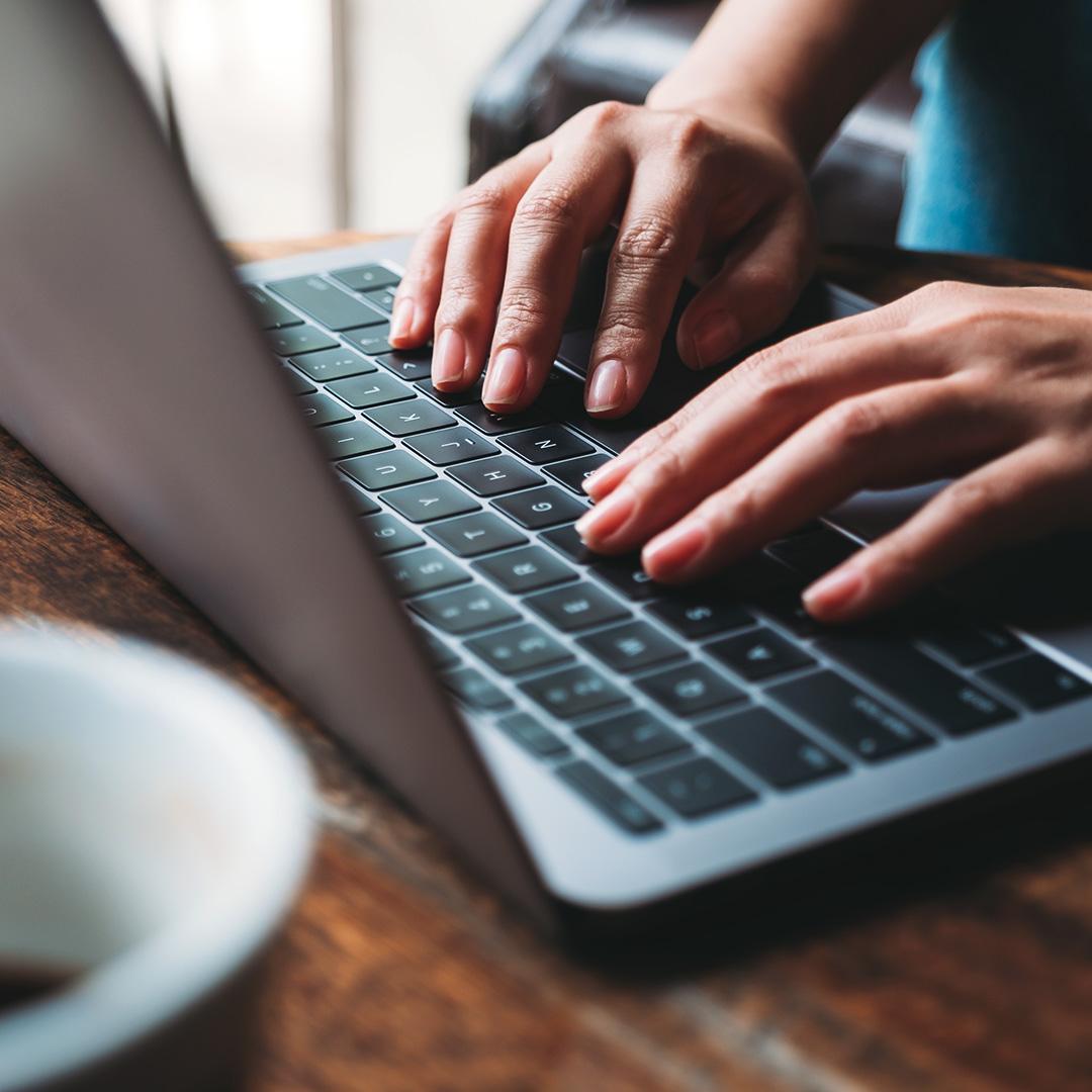 content marketing typing on laptop