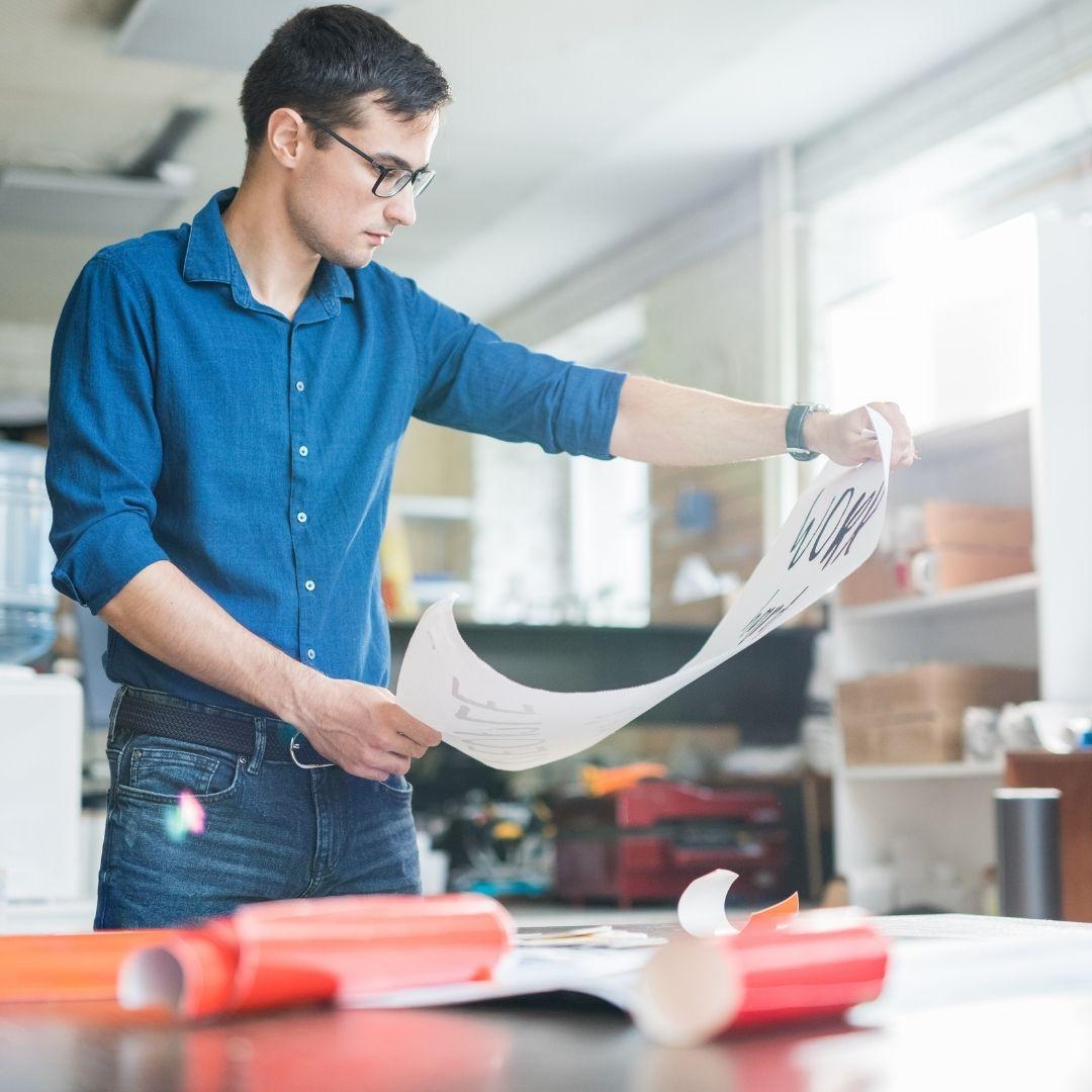 man looking at poster