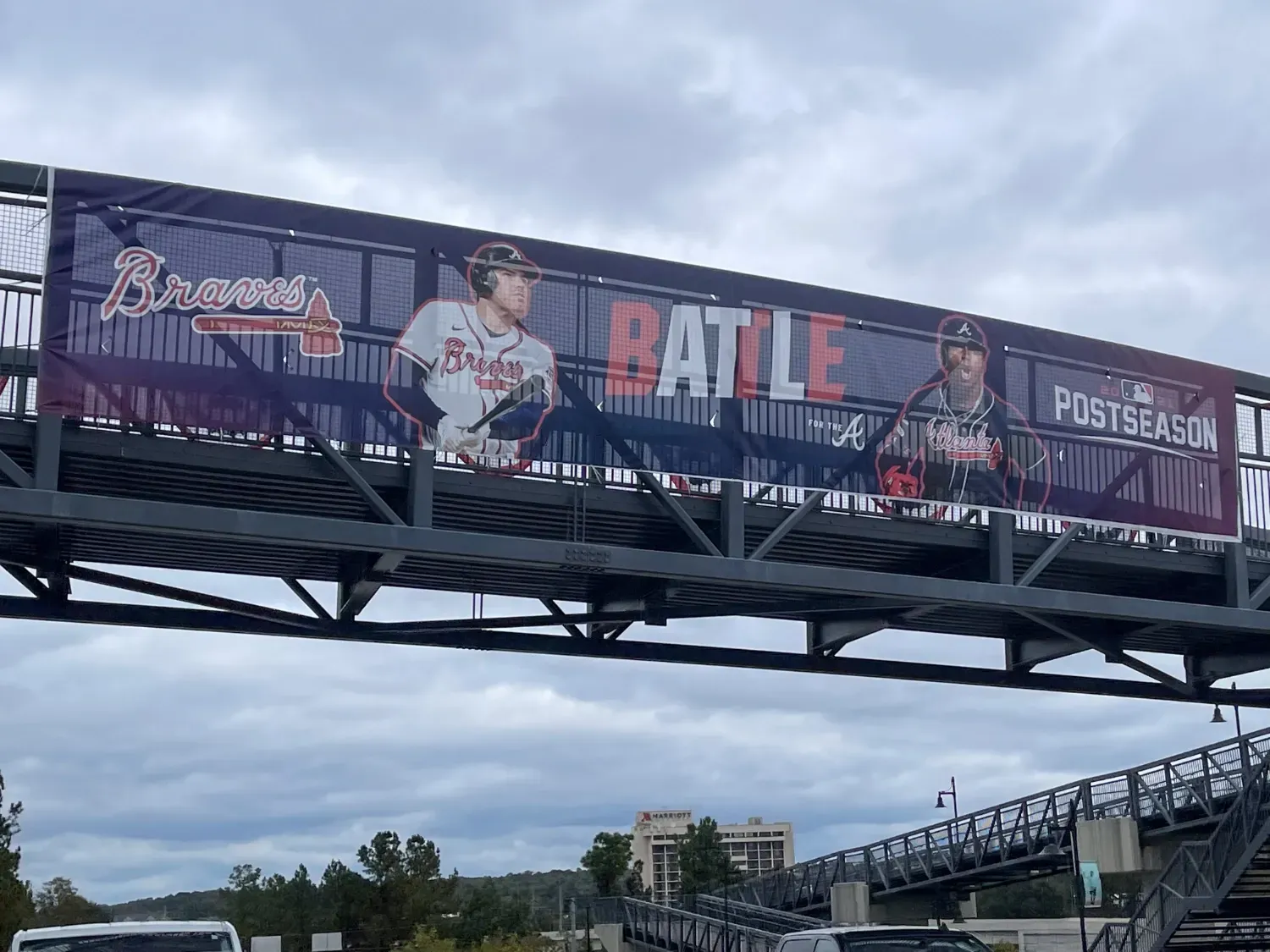 A sports banner overhanging a roadway.