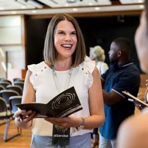 A woman holding a brochure featuring minimal design