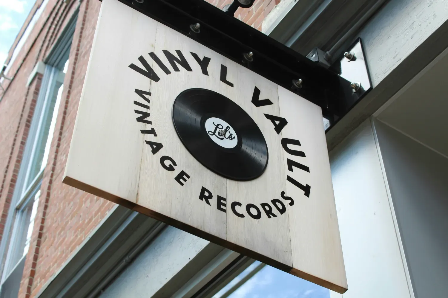 A photo of a wooden record shop sign.