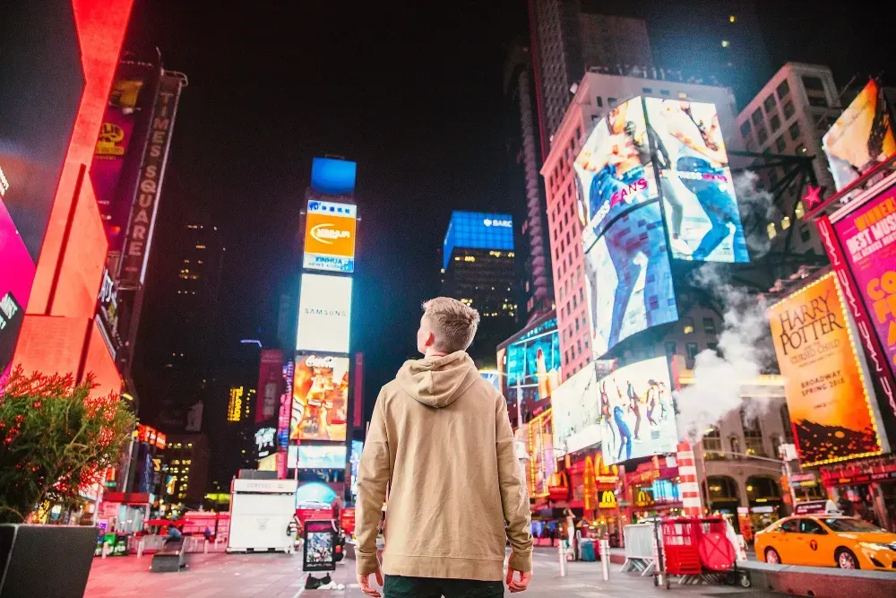 An image of a man standing in Times Square.