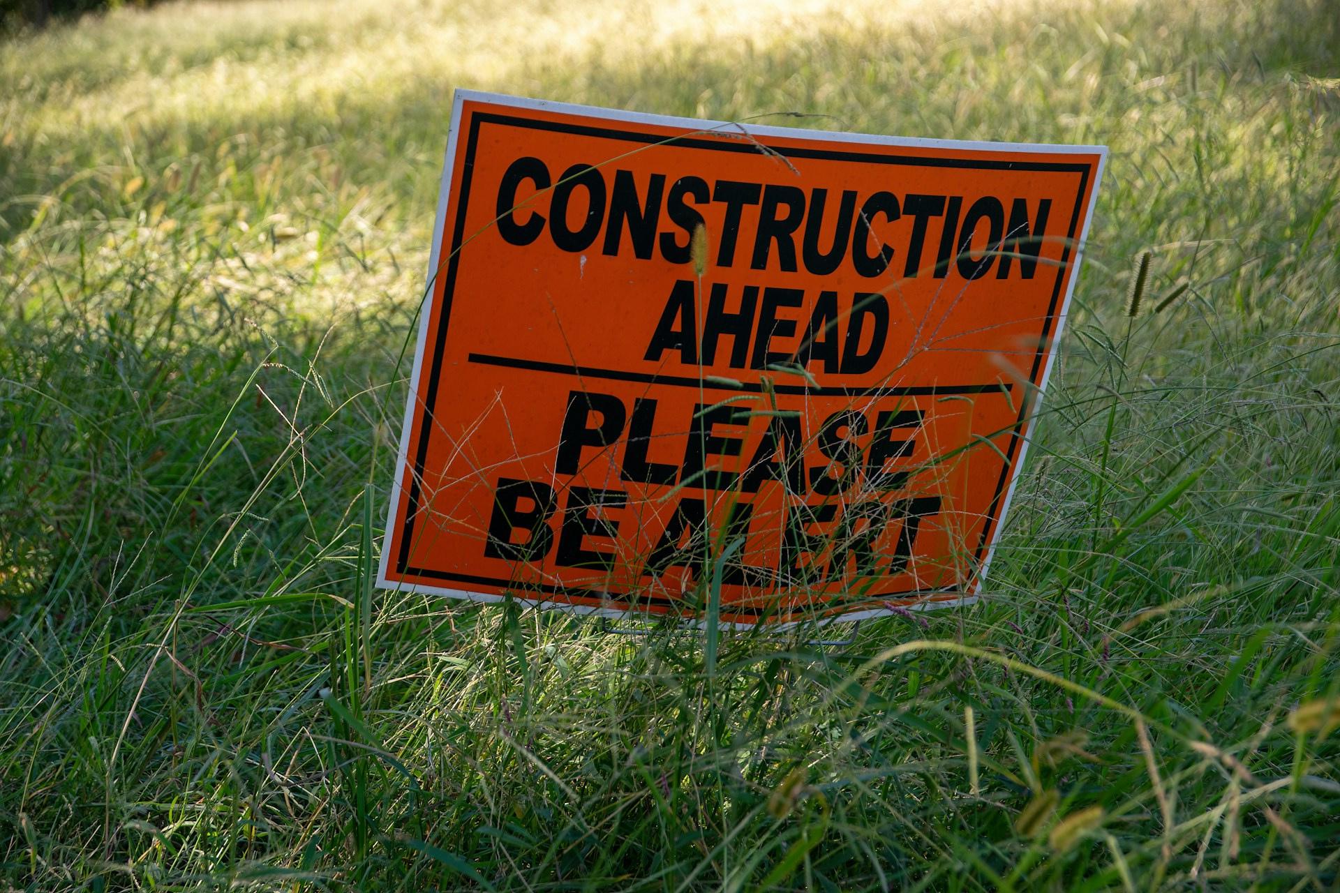 Temporary 'Construction Ahead' Sign posted in grass