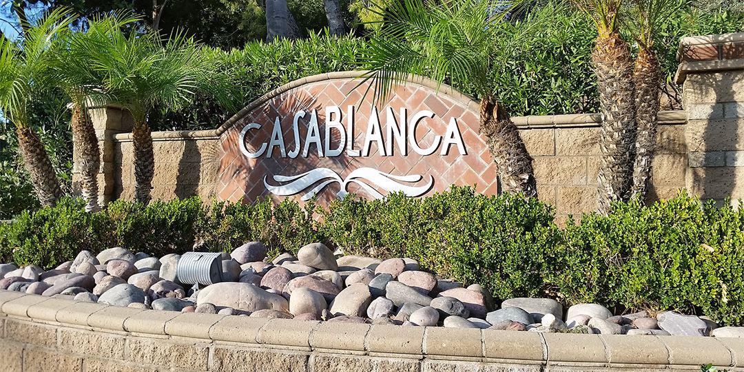 Dimensional flat cut metal letters and logo applied to tiled monument sign