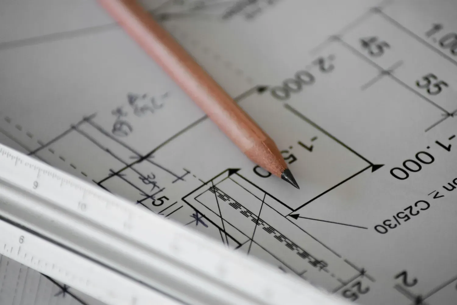 A closeup of a pencil on a blueprint.