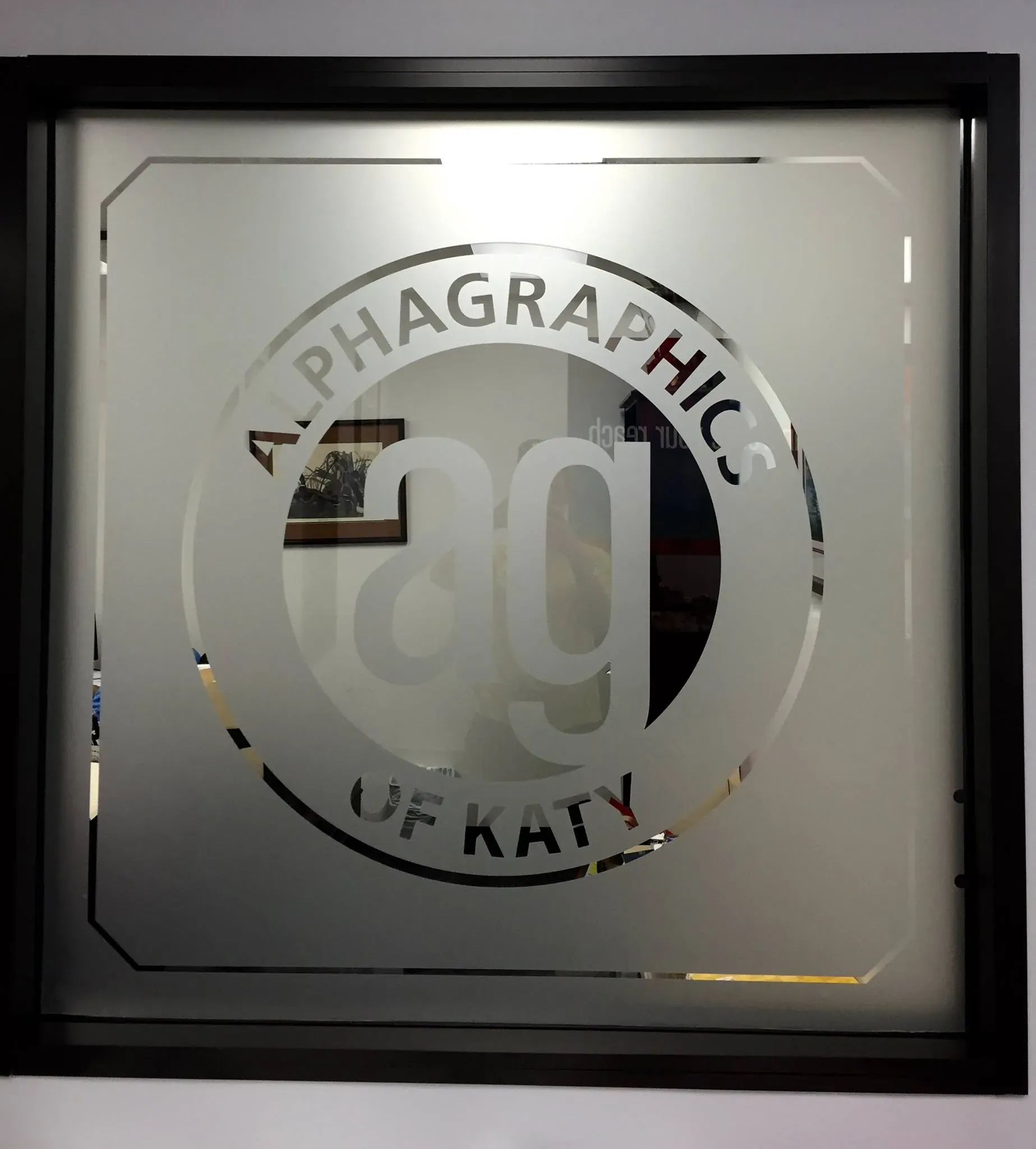Frosted vinyl AlphaGraphics of Katy logo on glass
