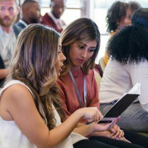Women looking at event program