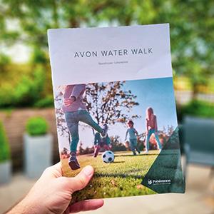 A brochure being held out