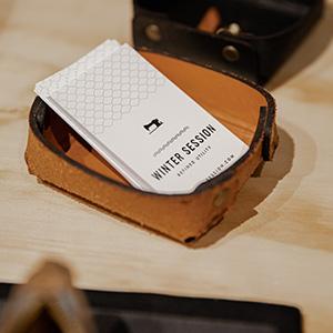 A stack of business cards in a leather holder