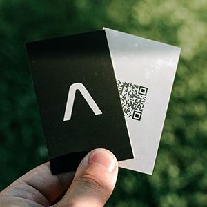 A business card with a QR code on it