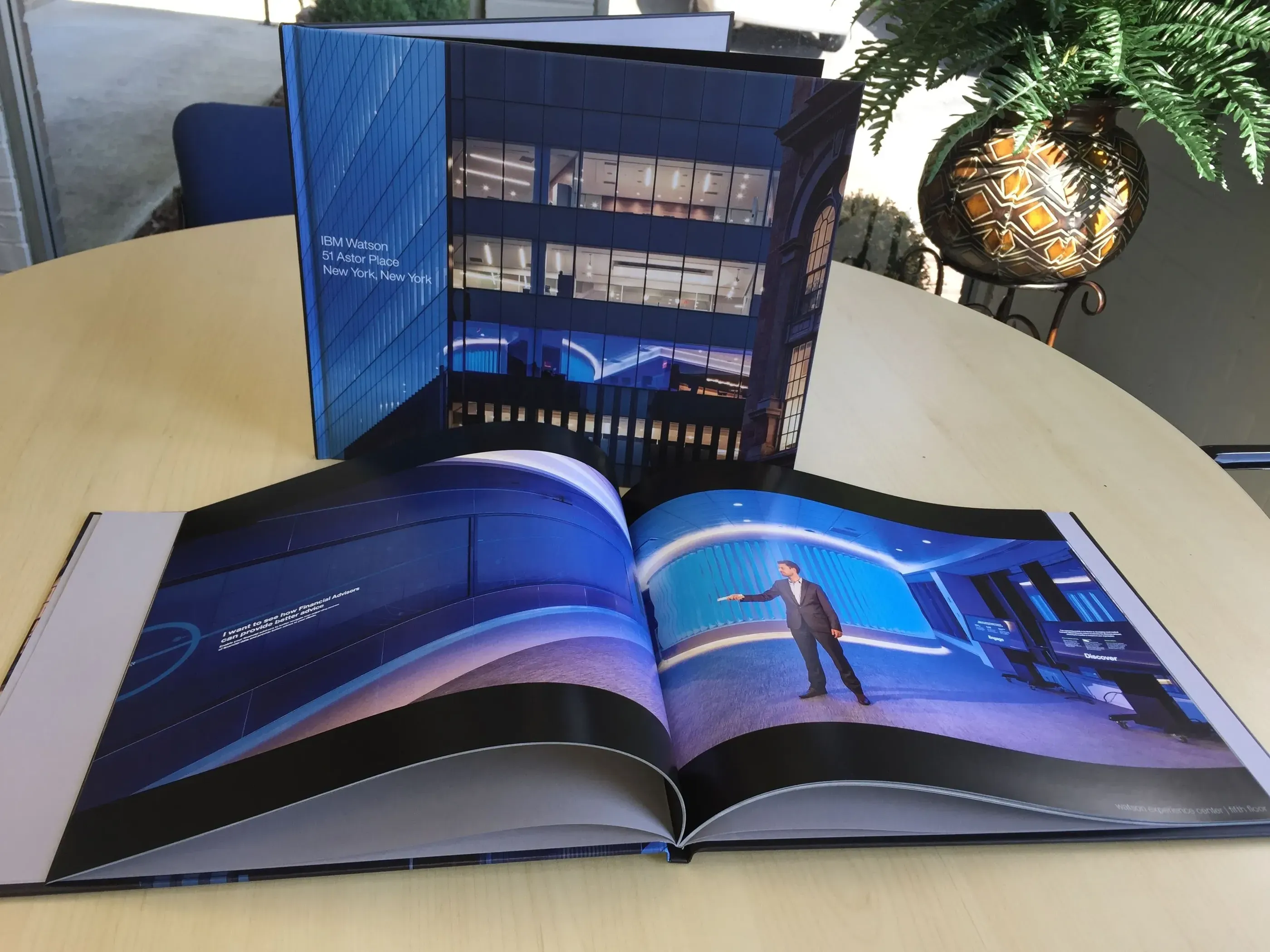 Hardcover coffee table book open on a table