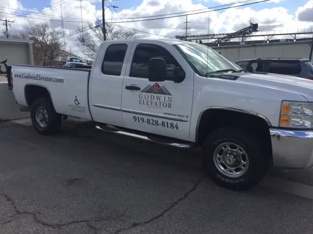 Pickup truck with door lettering for an elevator company