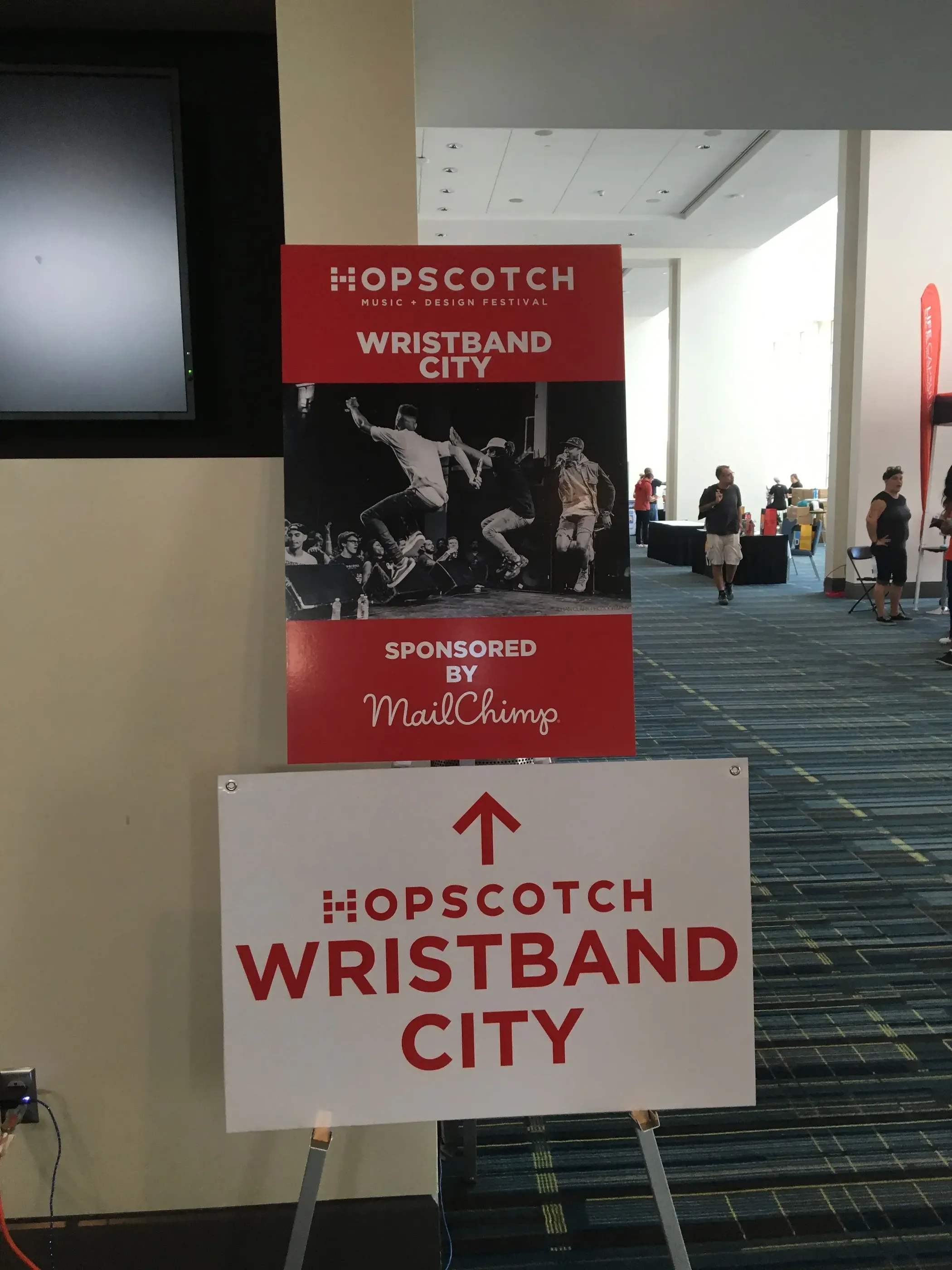 Hopscotch Wristband City directional sign on an easel