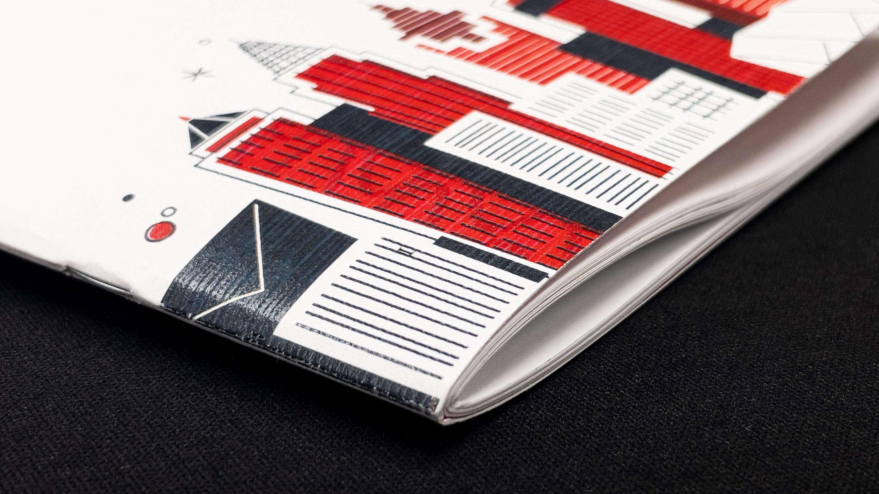 A photo of a booklet with saddle stitching
