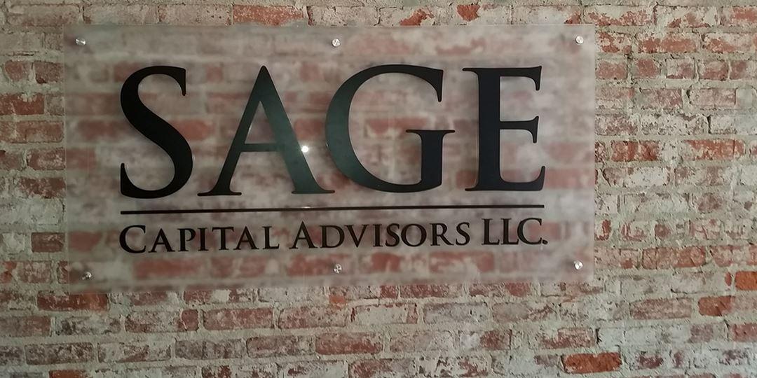 Dimensional letters on acrylic mounted using stand-offs