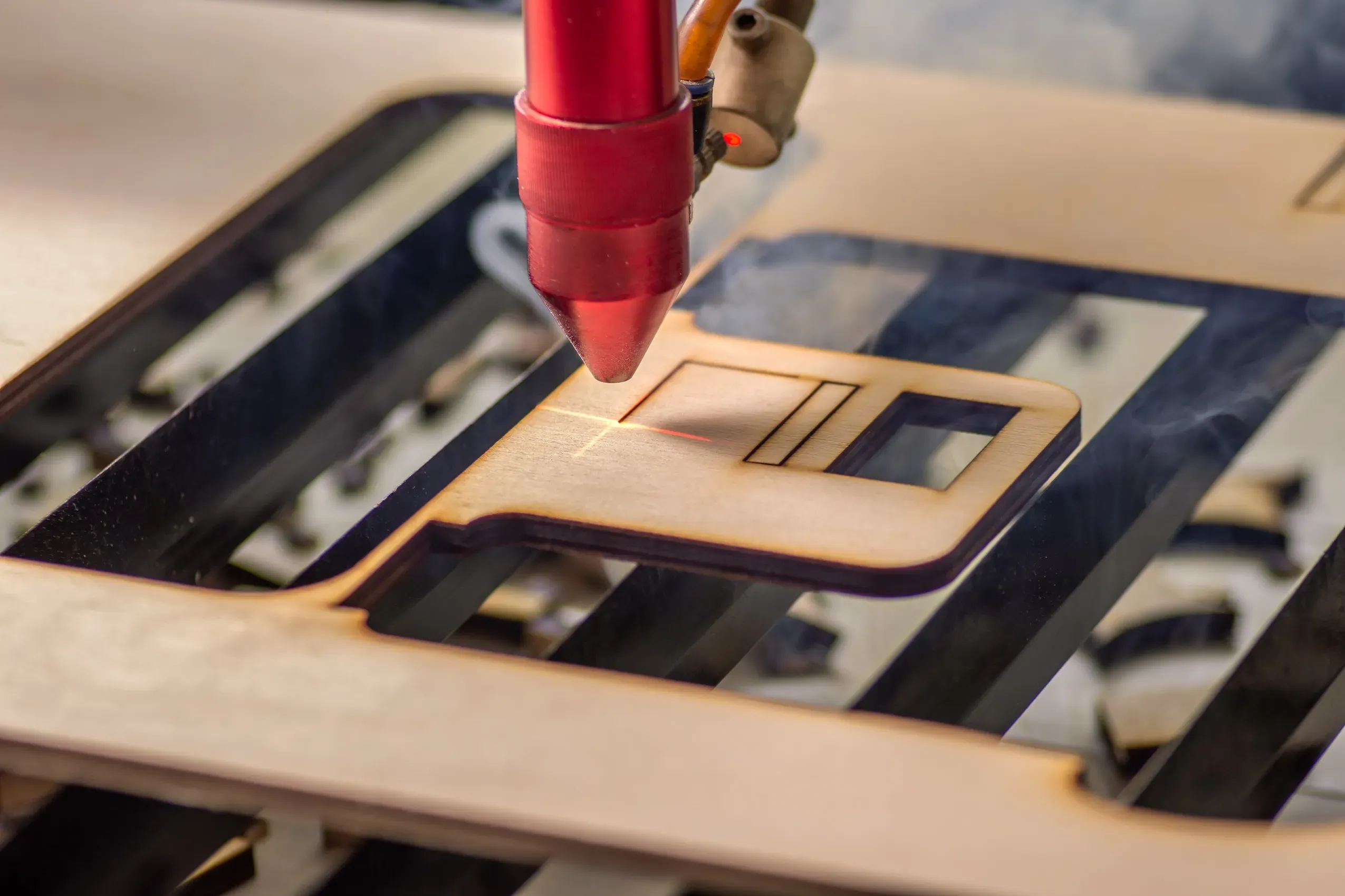 Laser etcher working and engraving wooden board