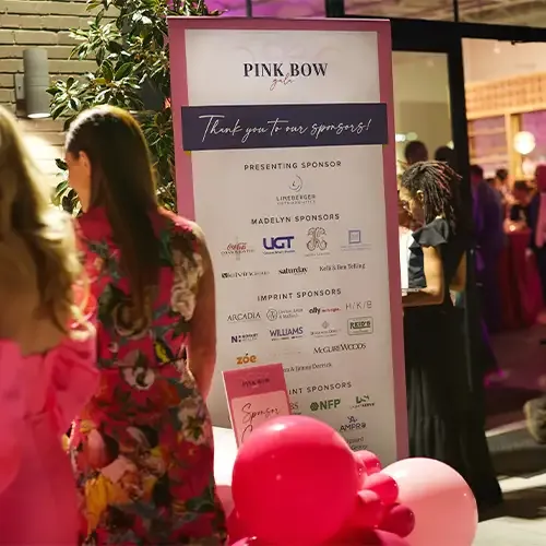 Guests stand near a sign that says 
