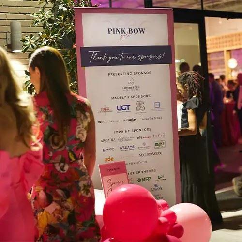 Large sign with Pink Bow Gala sponsor logos under the header