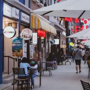 Foot traffic by a row of restaurants and businesses
