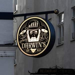 A round illuminated business sign on a building exterior