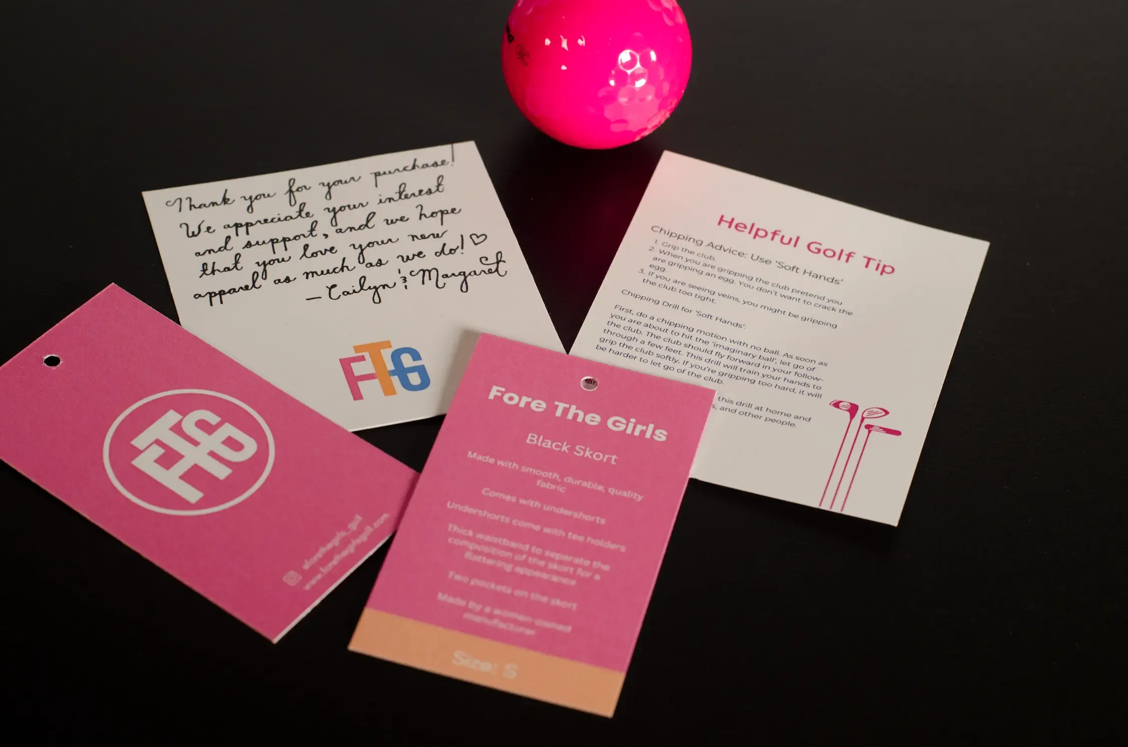 A collection of printed materials including a thank-you card, a helpful golf tip card, and product tags for