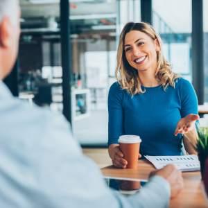 A customer service representative speaking with a client at a meeting