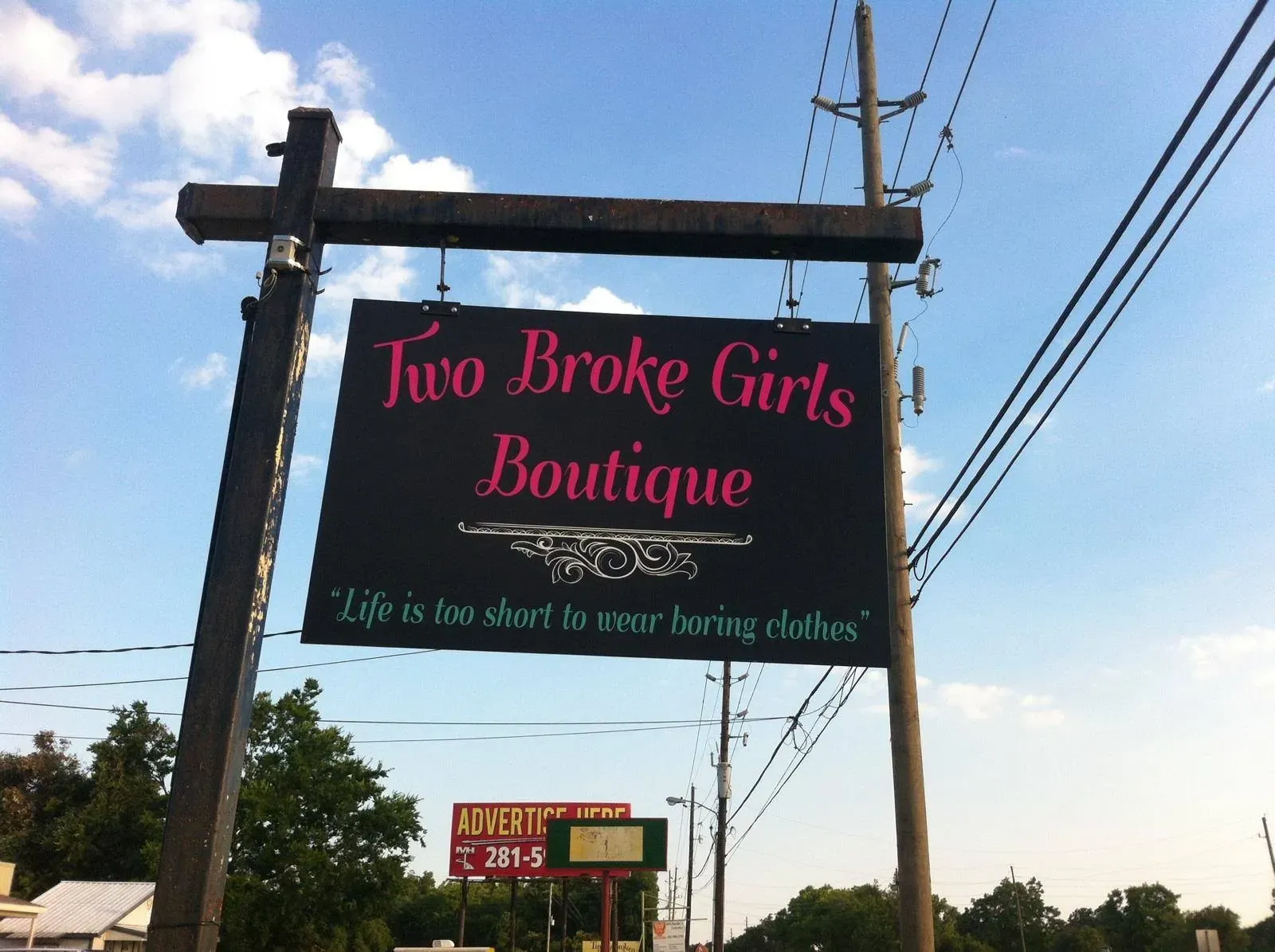 Hanging post sign for a boutique