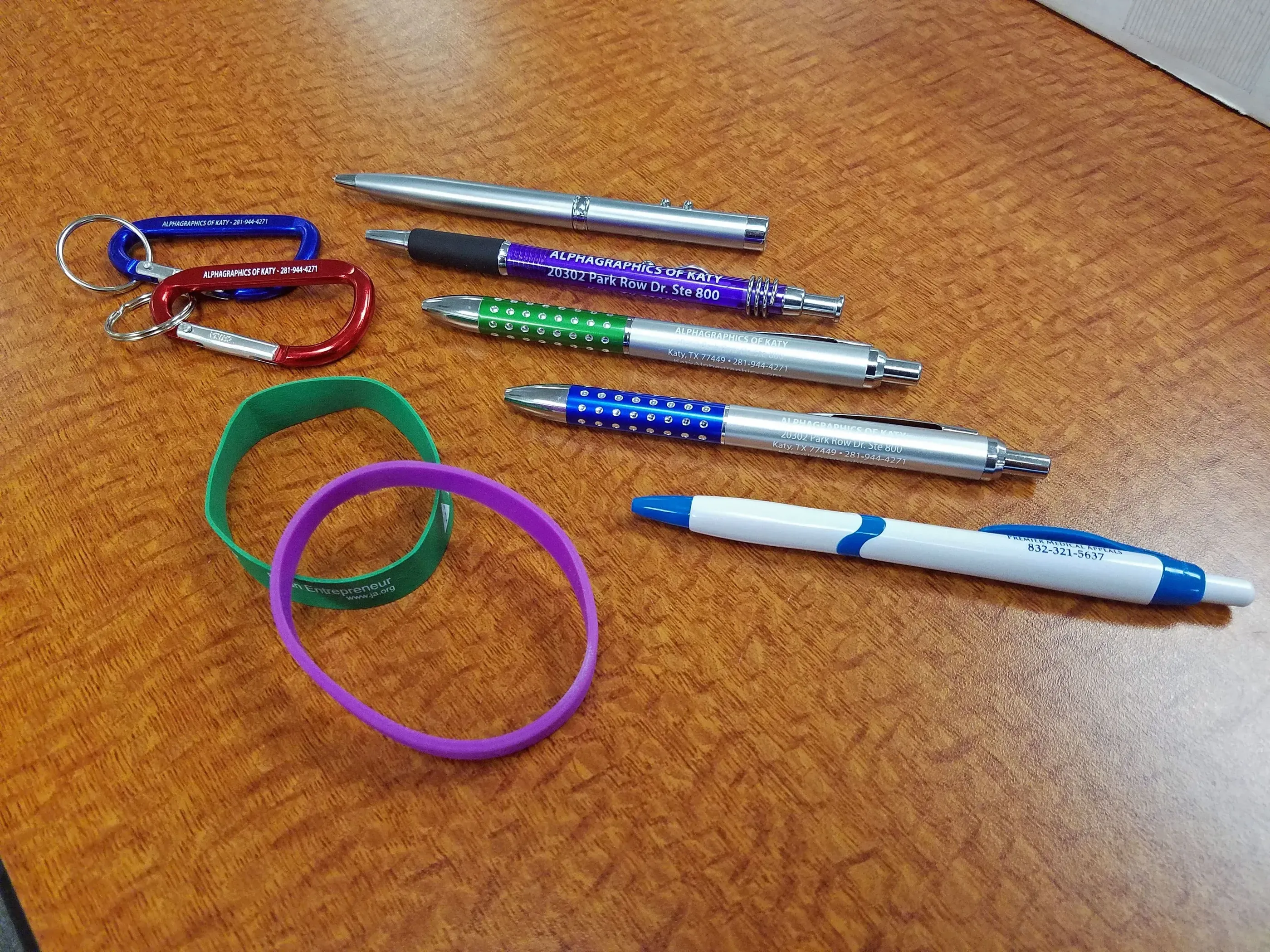 Promotional pens, wristbands, and carabiners