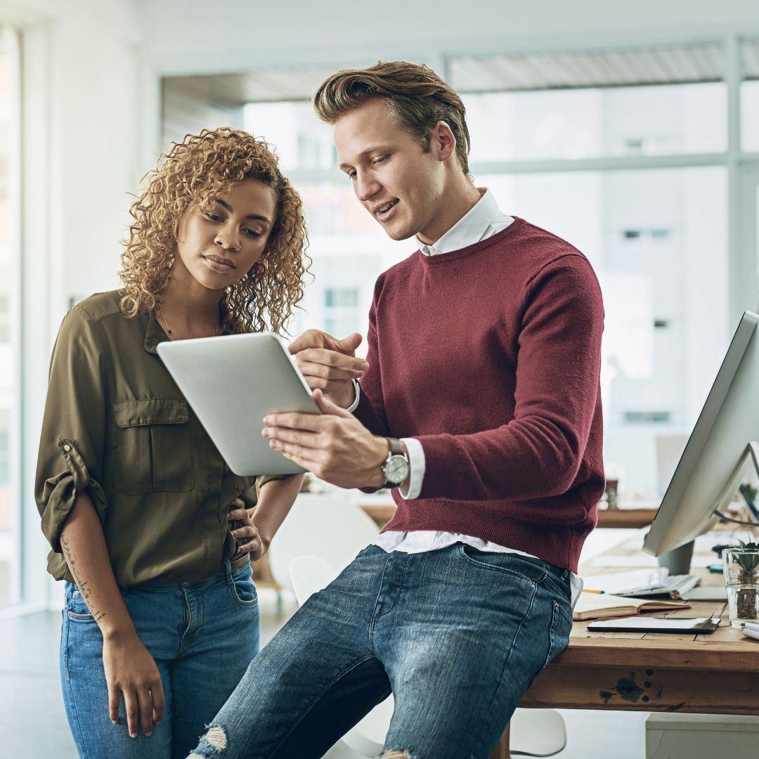 a man and woman looking over analytics of a marketing campaign