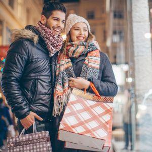 Holiday shoppers looking at a business window
