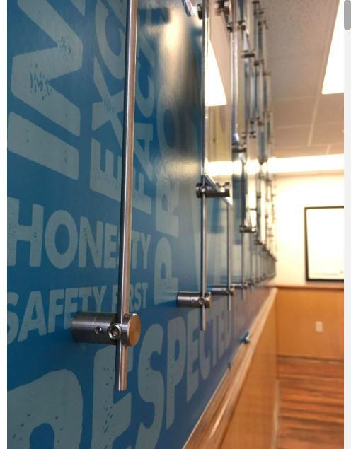Cable and standoff mounting system on a printed wall graphic