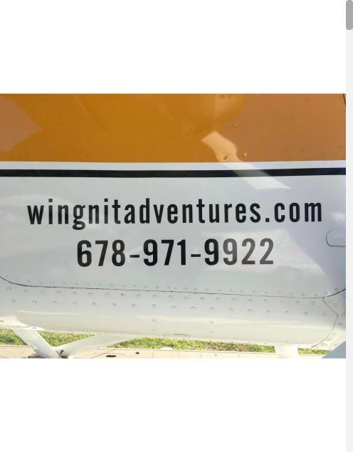 Website and phone number lettering on an aircraft